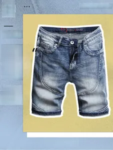 Detailed close-up of blue washed denim shorts featuring natural whisker grain and brand logo