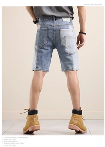 Detail showing color block patchwork and trendy distressed pockets on men's denim shorts