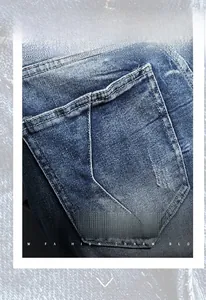 Close-up of vintage blue wash denim jeans showing reinforced back pocket and stitching