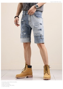 Detail of patchwork denim shorts featuring distressed holes and frayed textures