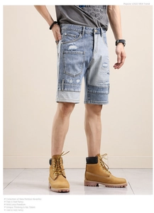 Close-up of patchwork denim shorts featuring distressed holes and frayed edges