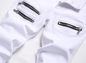 Close-up of white slim fit stretch jeans featuring stylish metal zipper decorative details