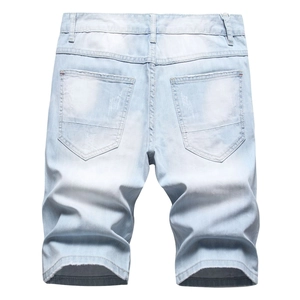 Detailed back view of light blue denim shorts with distressed pockets and raw hems