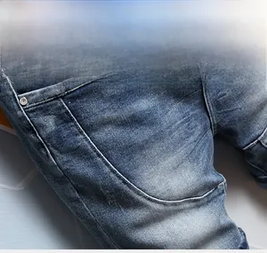 Detailed close-up showing panelled seams and stitching on vintage washed blue denim jeans