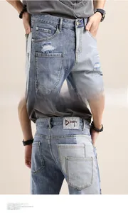 Detail of light blue patchwork denim shorts with distressed rips and leather design tag