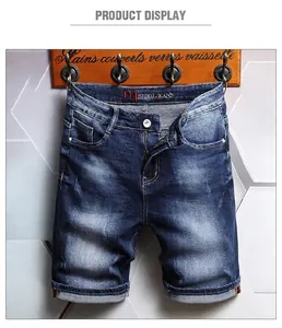 Detailed shot of men's washed denim shorts with vintage whiskers and cuffed hems