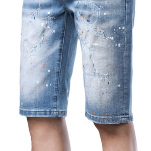 Distressed light blue denim shorts for men with paint splatter and ripped details