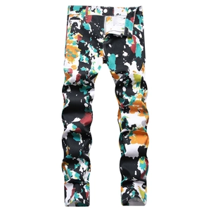 Men's slim-fit black jeans featuring vibrant multi-color graffiti paint splatter prints