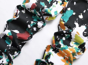 Detail of colorful abstract ink splash print on men's stretch twill denim pants