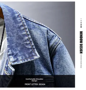 Detail of blue denim jacket showing yellow double stitching and washed texture