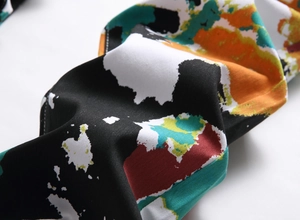 Macro shot of colorful graffiti street print and twill cotton fabric on slim denim jeans
