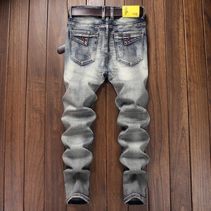 Men's slim fit stretch denim jeans in stone washed blue with a brown leather belt