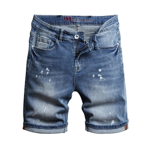 Men's light blue denim shorts with artistic paint splash and vintage washed finish