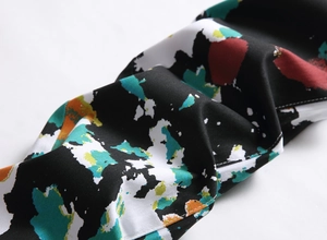 Close-up of street fashion denim jeans with colorful abstract graffiti print details