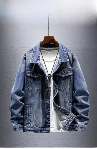 Detailed close-up of a classic blue washed denim jacket with flap pockets and metal buttons