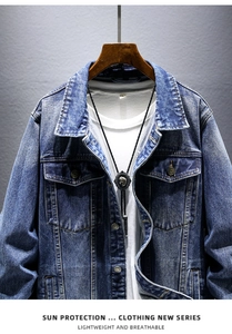 Detail of blue wash denim jacket with metal bolo tie and chest pocket details