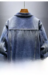 Detail view of the washed blue denim jacket back with contrast stitching and shoulder seam