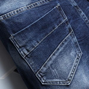 Men's blue washed denim shorts featuring detailed heavy stitching on rear pocket area