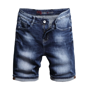 Men's washed blue denim shorts with whiskering, faded finish and rolled cuffs