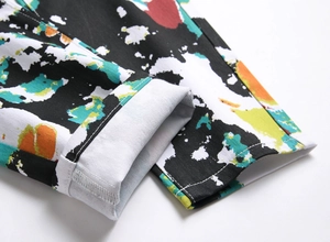 Close-up of street fashion jeans with colorful graffiti prints and cuffed hem detail