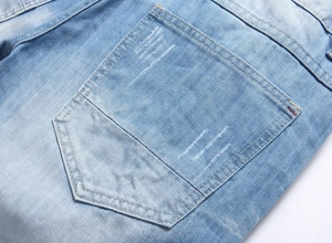 Close-up of light blue denim shorts featuring distressed details and precise stitching