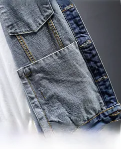Detail shot of denim jacket interior featuring a large functional pocket and contrast stitching