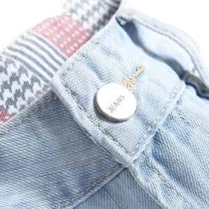 Men's light blue ripped denim shorts with silver logo button and patterned lining detail