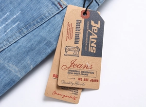 Detail of washed blue denim fabric with vintage tags and distressed edge texture