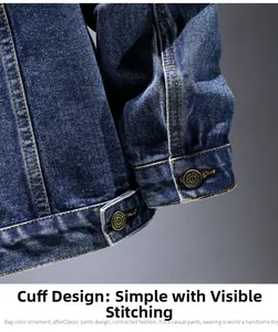Detail of dark blue denim jacket cuffs with vintage buttons and contrast stitching