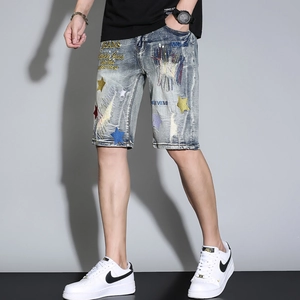 Men's retro blue distressed denim shorts with colorful star embroidery and patchwork detail