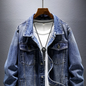 Men's mid-blue denim jacket with classic wash and metal buttons on a dark background