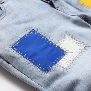 Slim fit light blue jeans for men with vintage patchwork details and white stitching