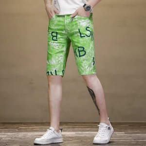 Détail du short vert pour homme avec imprimé graffiti blanc et broderie de lettres