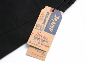 Detail of vintage paper tags on black denim jeans with Classic Fashion branding