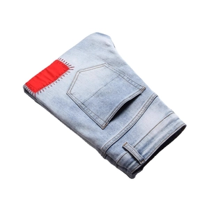 Men's slim fit light blue washed denim jeans featuring creative red patch embroidery style