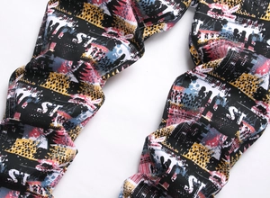 Detail of street art graffiti prints with ST letters on cotton twill jogger pants