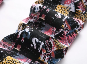 Macro view showing the vibrant street art print and soft knit texture of men's denim trousers
