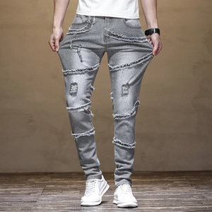 Men's slim fit light grey biker jeans with distressed ripped details and raw edges