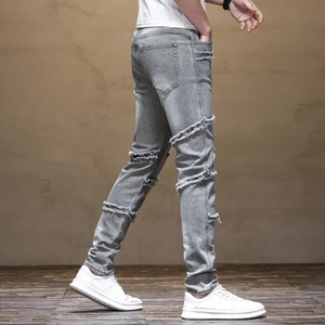 Slim fit light grey biker jeans for men with distressed ripped details and raw edges
