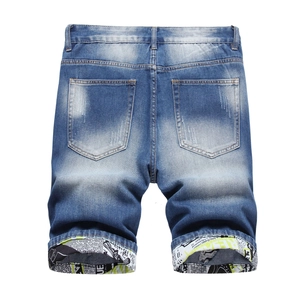 Slim fit men's blue distressed denim shorts featuring trendy graphic print folded cuffs