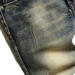 Men's vintage straight denim shorts with heavy wash effect and metal rivet detail