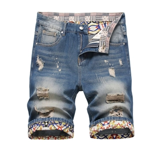 Men's slim straight distressed denim shorts with vintage ripped details and patch design