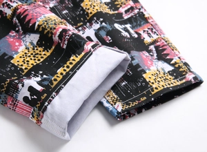 Detail of colorful graffiti print cuff with high-quality hem stitching on jeans