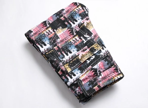 Detailed macro view of colorful graffiti print and stitching on folded men's skinny jeans