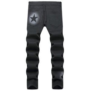 Men's black slim fit jeans with white star spray print and trendy stacked leg design