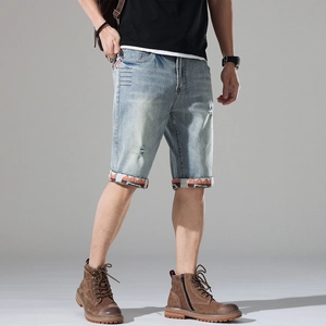 Men's light blue distressed denim shorts with ethnic embroidered cuffs and slim fit