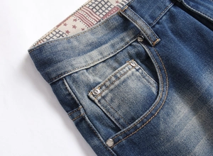 Dettaglio degli shorts in denim blu con rivetti e fodera interna con motivo a bandiera