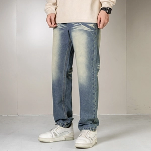 Detail of vintage blue straight jeans with whiskers and American retro wash effect