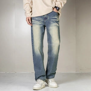 Detail view of retro blue washed jeans featuring vintage fading and whisker effects