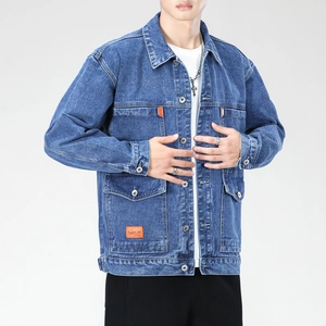 Detail of classic blue wash denim jacket featuring vintage metal buttons and orange brand patch